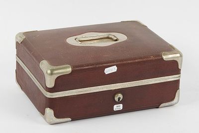 a brown suitcase sitting on a white surface