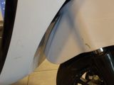 a close up of a white motorcycle with a black tire