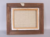 an old picture frame with a piece of fabric hanging on the wall
