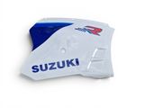 a close up of a motorcycle side panel with the suzuki logo on it