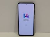 a close up of a phone on a table with a logo on the screen