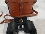 an old pair of binoculars sitting on top of a white cloth