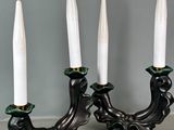 pair of white and green candle holders on a gray surface
