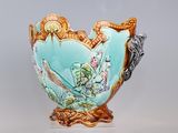 a blue vase with a bird on it on a stand