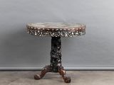 a small table with a marble top on a wooden stand