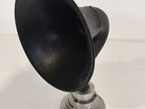 an image of a black and silver speaker on a white surface