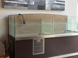 a fish tank sitting on top of a dresser in a living room