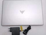 a laptop with a charger attached to it on a table