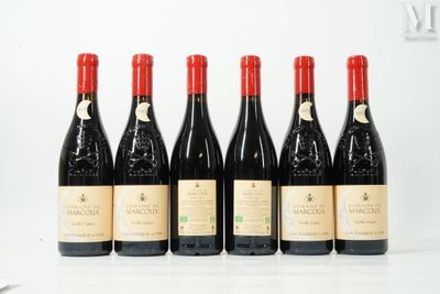 six bottles of wine are lined up on a table