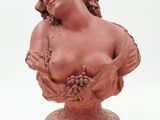 sculpture of a woman holding a bunch of flowers on a pedestal