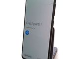 a phone that is sitting on a stand on a table