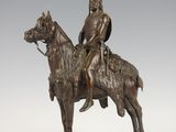bronze statue of a man on a horse with a shield on his head