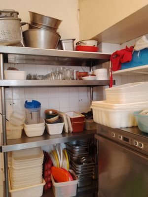 de nombreuses casseroles et poêles sur les étagères de la cuisine