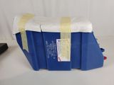 a blue plastic container with a yellow tape on top of it