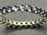 an image of a ring with blue stones in it