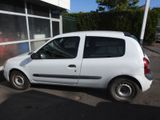 a small white car parked in front of a building