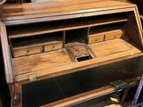an old wooden desk with a drawer on top of it