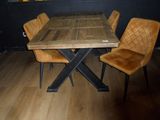 a wooden table with four chairs around it on a hard wood floor