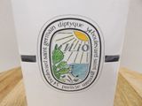 a cup with a sticker on it sitting on a table