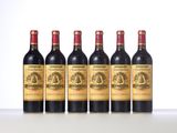 four bottles of wine are lined up on a table