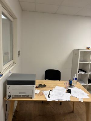 a desk with a printer and a printer on it