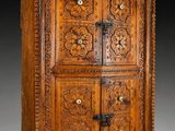 an old wooden cabinet with carvings on the doors and drawers