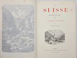 an open book with a picture of a village and mountains in the background