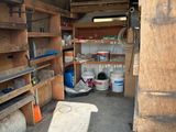 a garage with a lot of shelves and tools in it
