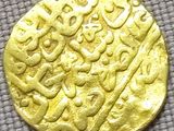 an image of a gold coin with a design on it