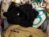 a pile of clothes in a bag on the floor