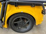a close up of a yellow car with a black roof