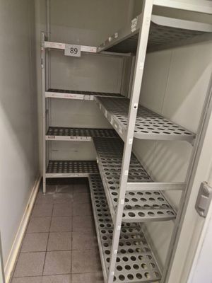 a pantry with shelves and shelves that have holes in them