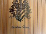 an image of a close up of a wooden guitar with a coat of arms on it