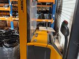 a fork lift truck that is parked in a warehouse