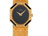un gros plan d'une montre-bracelet en or avec un cadran noir
