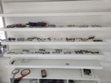 many pairs of glasses on the shelves in the room
