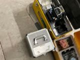 a suitcase with a camera and other items inside of it