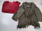 two sweaters that are sitting next to each other on a table