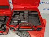 two tools in a red case sitting on a table