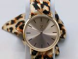 an image of a watch with a leopard print band on a white surface