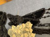 a black and gold bralet and a black and gold bralet on a gray couch