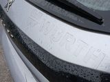 a close up of a car ' s emblem on the side of the car