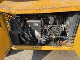 a large yellow machine that is sitting in the dirt