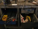a workbench with tools in the middle of the room
