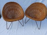 pair of wicker chairs with metal legs on a white background