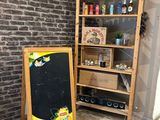 a chalk board next to a chalk board in front of a brick wall