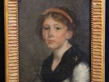 a painting of a woman with a red headband in a gold frame