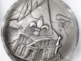 an image of a silver coin with a castle on it