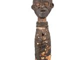 an old wooden statue of a man with a face on it ' s head