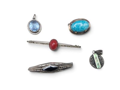 several pieces of jewelry are arranged on a white surface
